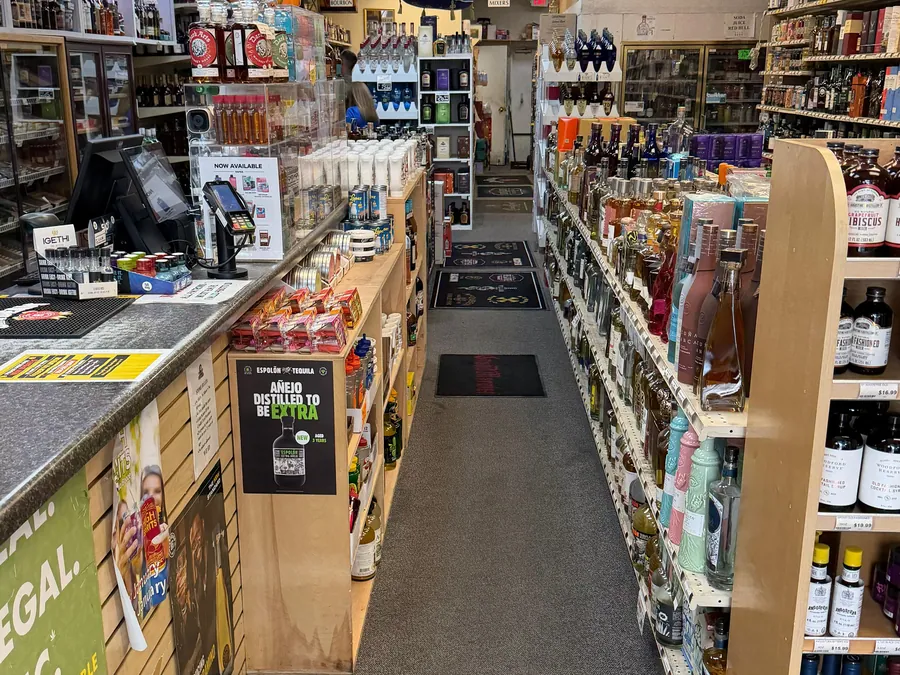 The counter and main aisle at Golden747 Liquors
